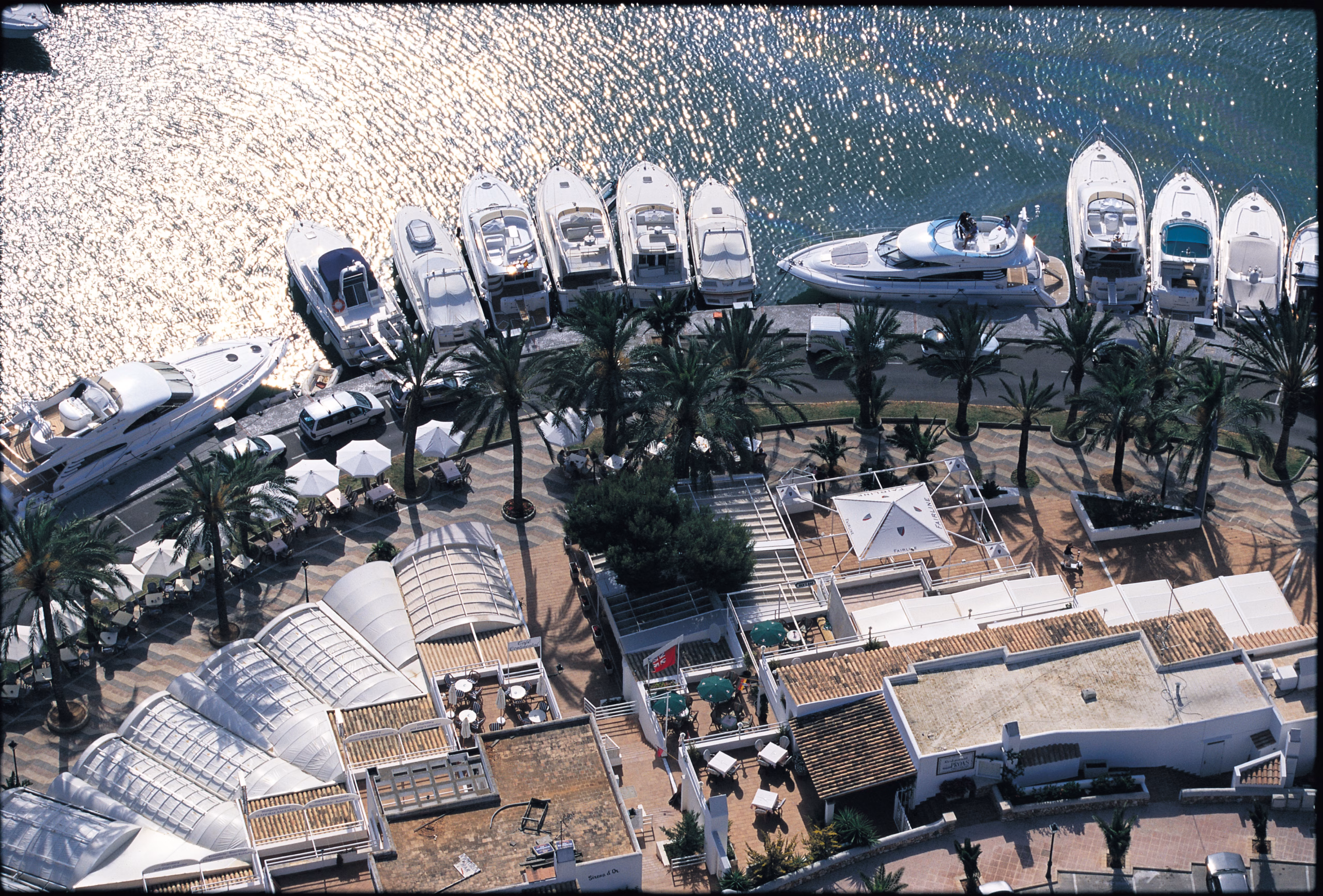 Luxury yachts in sunny harbor.
