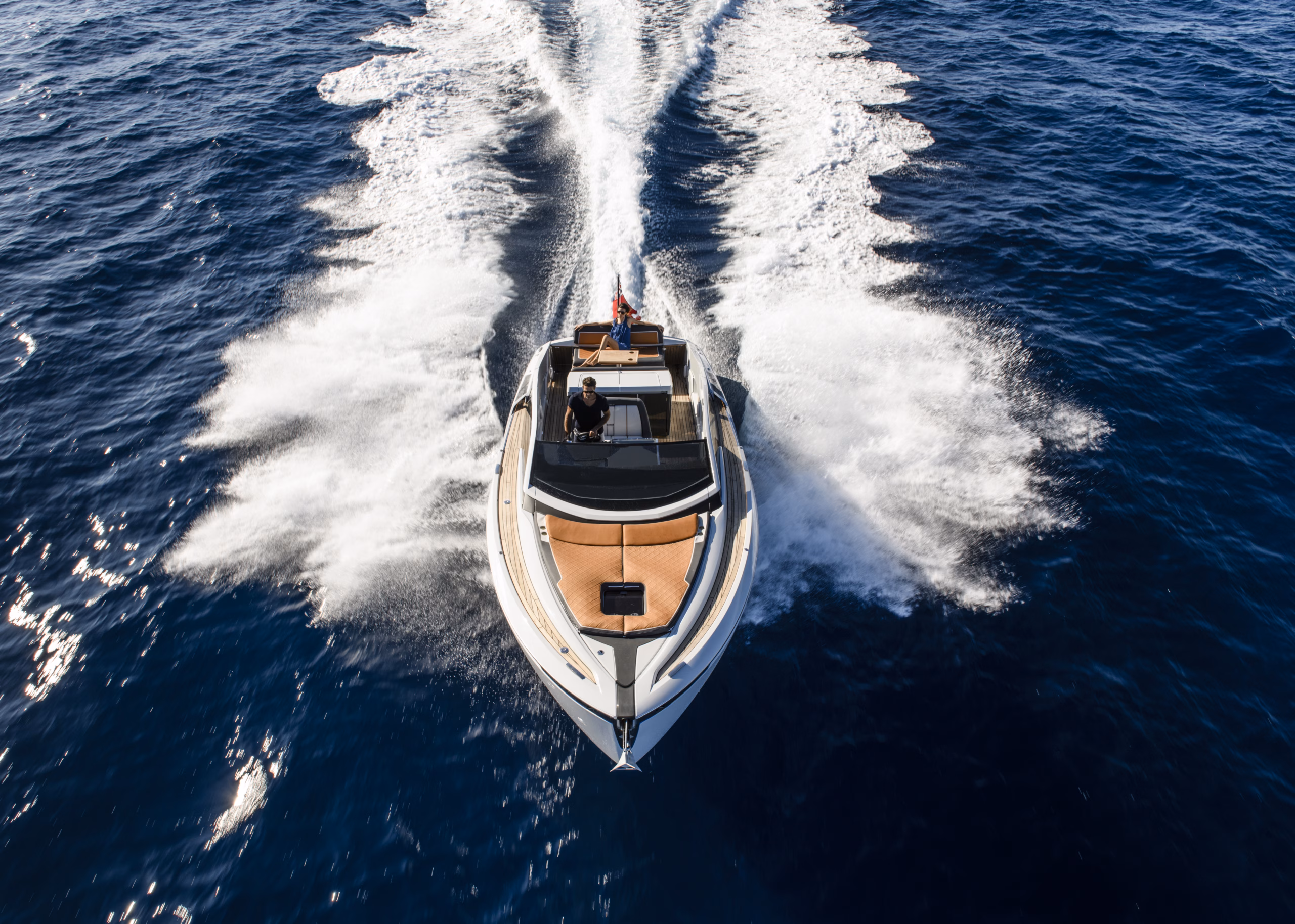 Speedboat cutting through blue ocean.