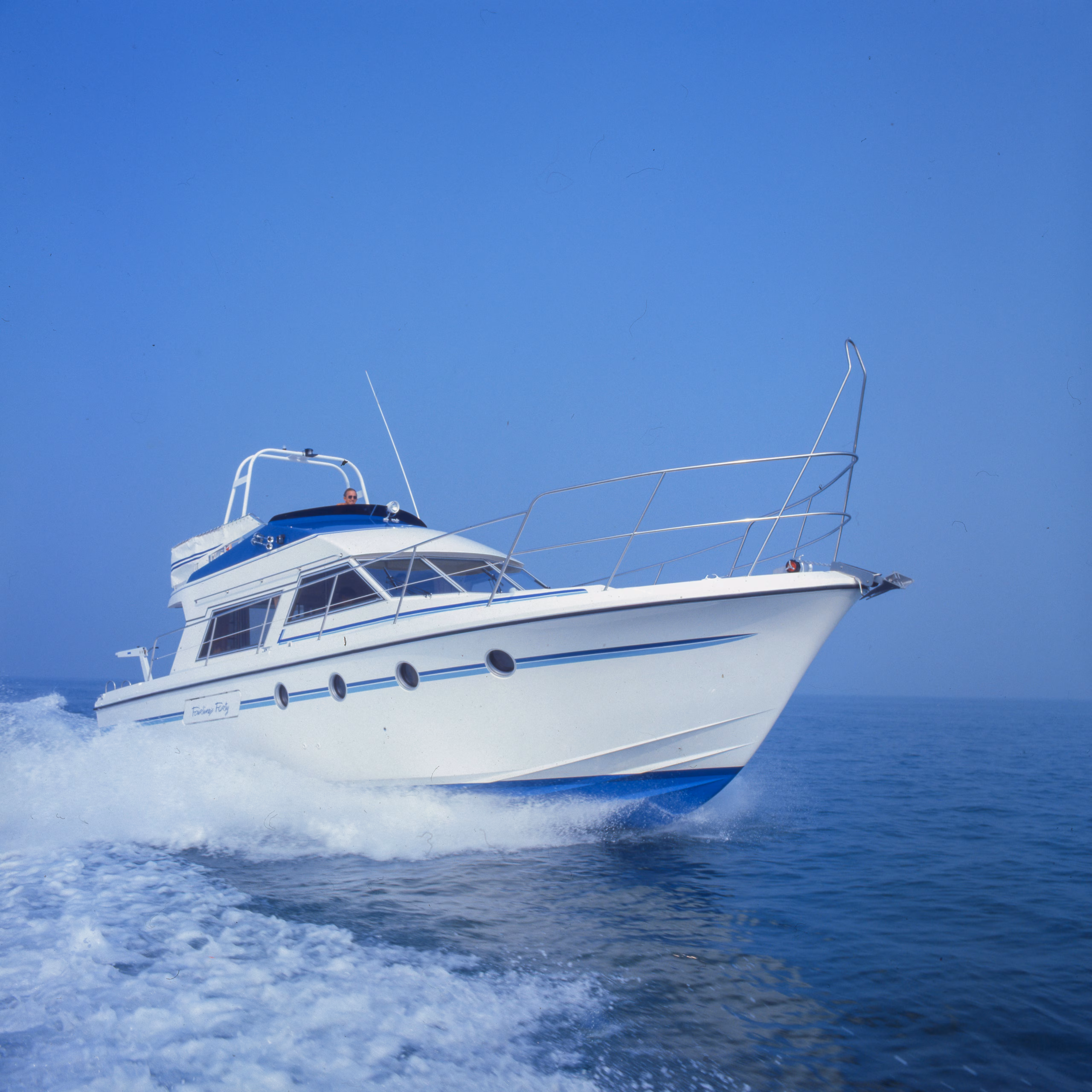 White motorboat on blue water