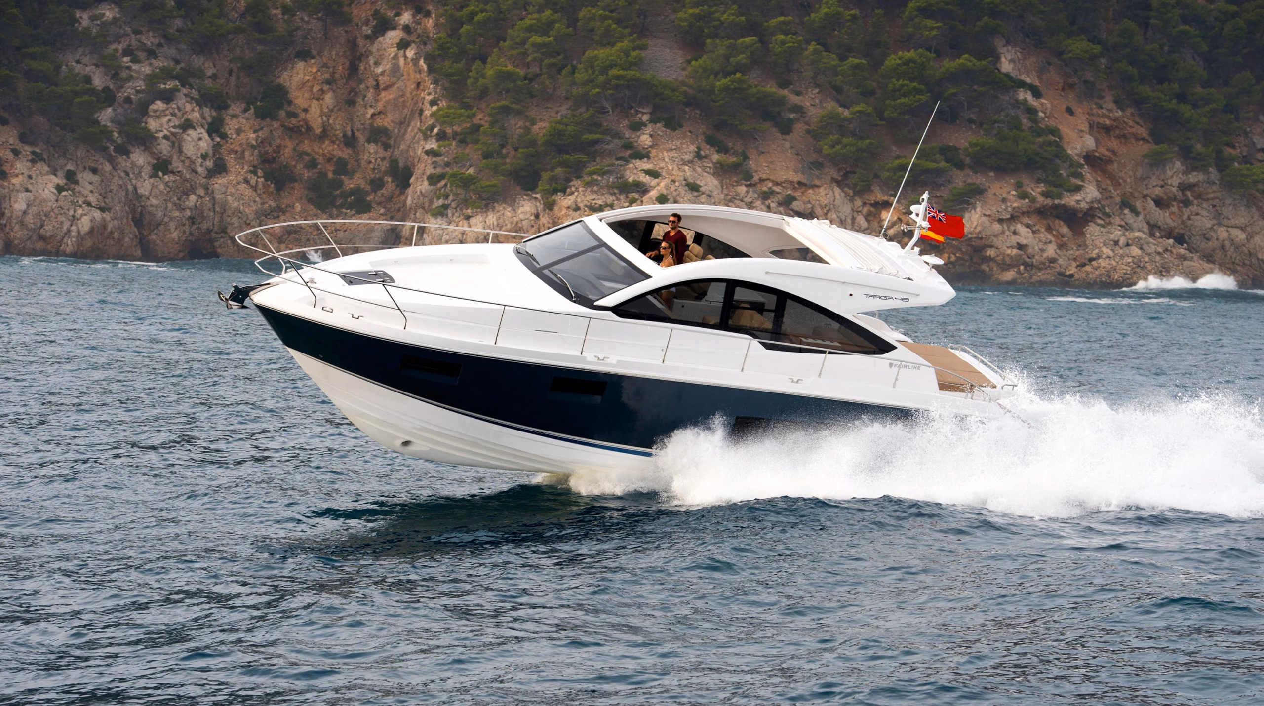 Luxury yacht speeding through waves