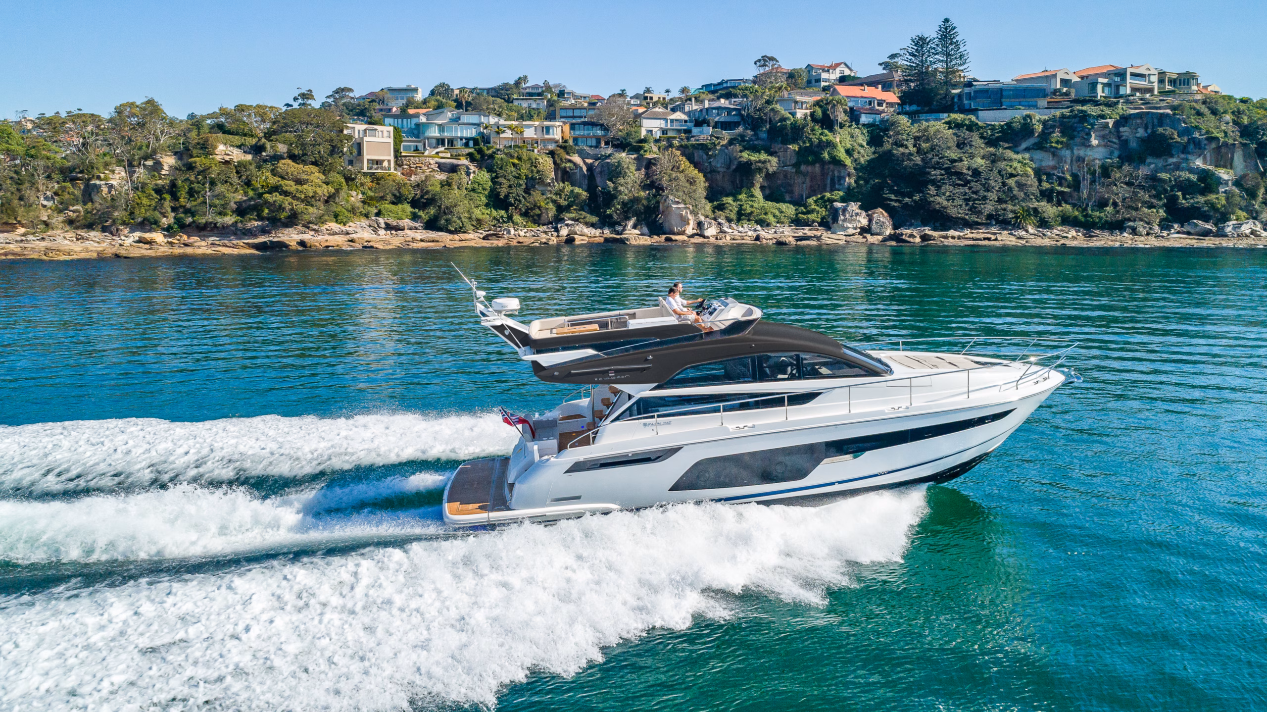 White yacht cruising on blue water.